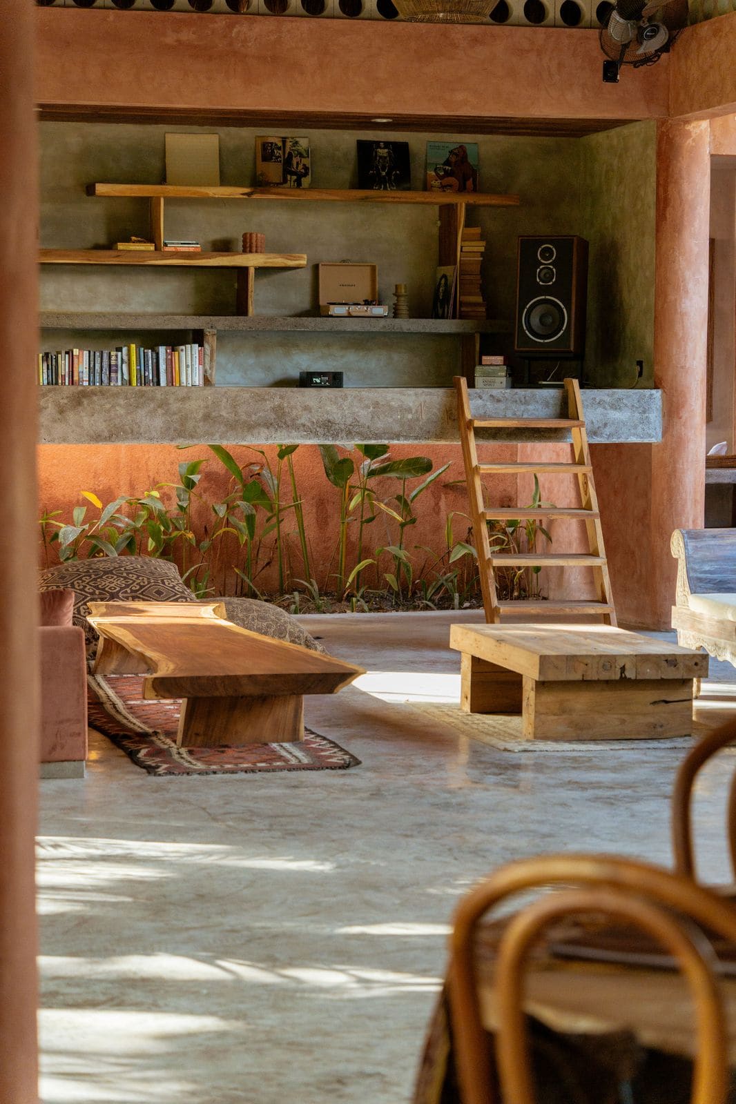 The cafe's lounge: terracotta walls, record player, book shelves and low wooden tables.